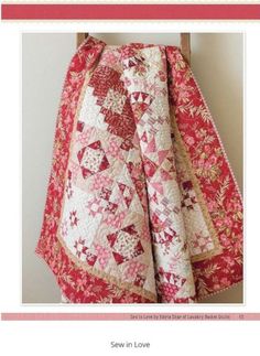 a red and white quilt on a wooden chair