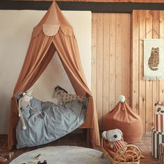 a child's bedroom with a canopy bed and stuffed animals