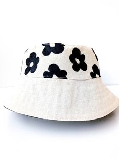 Flower Bucket Hat, White Bucket Hat, Handmade, Handpainted Fashionable and comfortable bucket hat head accessory. Perfect for covering the face and eyes from sun All hats are painted by hand so there might be some ever-so-slight differences (maybe a thicker/thinner brush stroke in some spots) No screen printing or vinyl transfers, it's all made from the heart baby :) Each of these handmade hats is personally sewn and handpainted.  You can also combine your bucket hat with a trendy bag to create Cream Adjustable Bucket Hat, Adjustable Bucket Sun Hat For Spring, Adjustable Bucket Shape Sun Hat For Spring, Spring Adjustable Bucket Sun Hat, White Bucket Sun Hat For Vacation, White Summer Bucket Hat For Festivals, Spring Bucket Sun Hat, Adjustable Natural Bucket Hat, Adjustable Natural Color Bucket Hat