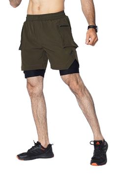 EGNAR Cargo Short in a high-performance short. The silhouette is distinguished by two zippered cargo pockets on the shell. The shorts feature a built-in liner with two media pockets for bounce-free storage, mesh panels for ventilation, anti-odor technology. The backside features a utility loop for a shirt or towel while training. The drawstrings tips are heat-dipped and the side splits are reinforced with tack seams to increase overall durability. Features Slim fit Egnar logo Woven, compression-lined short 5.5" Inseam Side Zip pockets Techwear Sports Shorts With Built-in Shorts, Functional Compression Athletic Shorts With Pockets, Sports Athletic Shorts With Cargo Pockets, Athletic Sports Shorts With Cargo Pockets, Outdoor Compression Athletic Shorts With Built-in Shorts, Athletic Cargo Shorts For Sports, Compression Athletic Shorts With Side Pockets, Athletic Shorts With Cargo Pockets For Sports, Green Cargo Sports Shorts