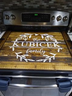 a wooden cutting board sitting on top of an oven