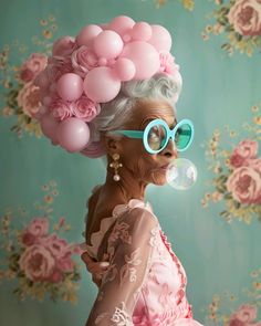 an old woman with glasses blowing bubbles on her face