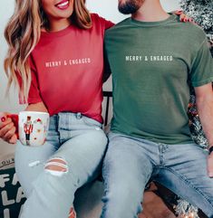 Welcome to DukeAndPine LLC! These Merry and Engaged Comfort Colors® shirts will be wonderful gifts to give an engaged couple or even a special way to announce a Christmas Engagement!  Product Information ▸ Comfort Colors® C1717 T-shirt that is a unisex, relaxed fit ▸ 100% ring-spun cotton ▸ This is a Direct-to-Garment (DTG) printed item where the ink of the design is printed onto the item ▸ Rolled sleeves in pictures are for styling purposes only and props used in photos are not included with pu Matching Engagement Shirts, Engagement Shirts, Engaged Christmas Shirt, Couples Christmas Tshirts, Engaged Couple Christmas Card, Christmas Engagement Announcement, Engaged Af Shirt, Matching Tshirts, Christmas Engagement