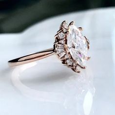 a close up of a diamond ring on a table