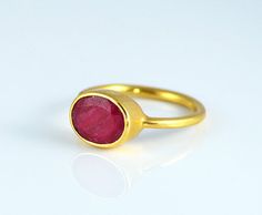 This beautiful stackable bezel set ring is made with oval faceted Dyed Ruby gemstone in 18K Vermeil Gold. The ring has a 925 stamp. Gemstone size Oval Ruby Ring For Valentine's Day, Oval Ruby Filigree Ring As Gift, Oval Cabochon Ruby Ring Gift, Valentine's Day Oval Ruby Ring, Classic Yellow Gold Ruby Ring With Oval Cabochon, Oval Cabochon Ruby Ring In Yellow Gold, Red Oval Cabochon Ruby Ring For Gift, Oval Cabochon Ruby Ring Birthstone Gift, Oval Cabochon Red Ruby Ring In 14k Gold