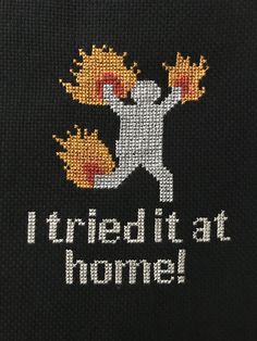 i tried it at home cross stitch pattern on black fabric with white and yellow lettering