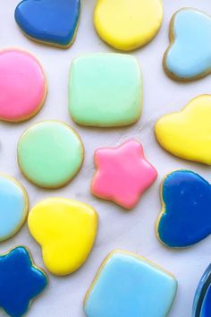 colorful cookies are arranged in the shape of hearts and stars