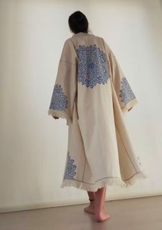 Enhance your wardrobe with this exquisite hand-embroidered long kimono, featuring stunning blue floral motifs. Crafted with meticulous attention to detail, this kimono seamlessly blends comfort and style, making it a versatile addition to any outfit. The natural beige fabric is beautifully contrasted by the intricate blue embroidery, adding a touch of elegance and cultural significance. Perfect for layering, this kimono is ideal for casual wear, beach cover-ups, festival attire, or as a statemen Boho Beachwear, Festival Kimono, Kimono Boho, Festival Attire, Boho Cardigan, Blue Embroidery, Long Kimono, Womens Robes, Boho Festival