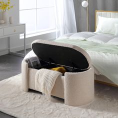 an open suitcase sitting on top of a white carpeted floor next to a bed