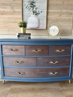 an old dresser is painted blue and gold