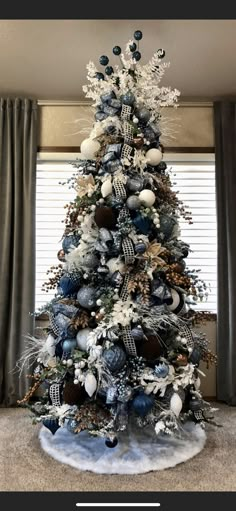 a blue and white christmas tree with silver ornaments