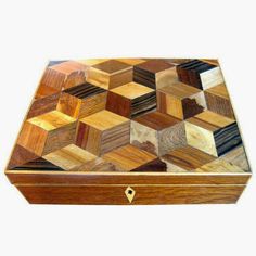 a wooden box that has many different types of wood inlays on the lid