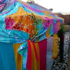 colorful cloths are tied to the back of a tent