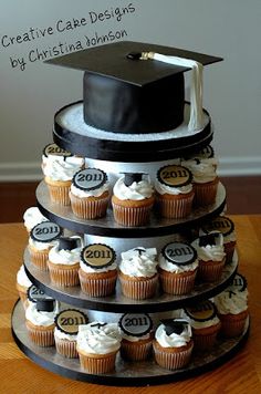 a tiered cake with cupcakes and a graduation cap on top