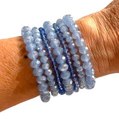 2 different shades of blue: Periwinkle/light blue and Aqua blue Set of 7 Bracelets: 2 small crystal looking, 2 opaque crystal small size and 3 opaque larger bracelets Fun to wear as a set or a couple at a time Stretch Beaded Bracelets, Down Arrow Icon, Different Shades Of Blue, Blue Periwinkle, Large Bracelet, Top Handbags, Bag Icon, Charm Rings, Slipper Socks