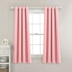 pink curtains hanging on the side of a window in a room with white walls and furniture