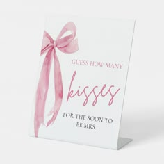 a greeting card with a pink bow on it that says, guess how many kisses for the soon to be mrs