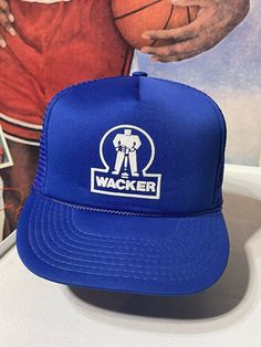 This vintage trucker hat is a must-have accessory for any 80s enthusiast. Its blue color with a mesh back and adjustable snapback make it a perfect fit for any head size. With a humorous WACKER logo on the front, this hat is sure to be a conversation starter. Ideal for completing any casual outfit, this hat is a great addition to your collection. Blue Retro Trucker Hat For Streetwear, Affordable Vintage Blue Trucker Hat, Blue Snapback Trucker Hat With Mesh Back, Retro Blue 5-panel Trucker Hat, Vintage Blue Snapback Hat, Vintage Trucker Hats, Hats Snapback, Trucker Cap, Trucker Hat