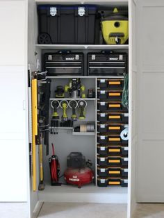 an organized garage storage unit with tools and other items in it's cabinet door