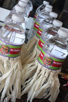 several bottles of water are lined up on the table