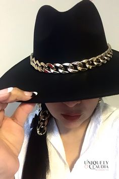 The very stunning Dakota Chain Band Hat is the perfect classy, trending and an absolute must have! The unique curb gold chain accent cowboy hat will surely turn heads! Adding this one-size hat to any outfit can give it just the kind of kick it may need! The chain above the brim adds a special and stylish touch. The soft wool material is desirable without any uncomfortable itch. Pair with a flowy dress, sandals and sunglasses in the summer. Accessorize with over the knee boots and a cardigan for Western Gold Hat Bands For Party, Western Style Gold Hat Bands For Parties, Gold Wide Brim Fedora For Party, Gold Fedora With Curved Brim For Party, Gold Curved Brim Hat Band For Party, Gold Hat Band For Party With Curved Brim, Gold Fedora With Short Brim, Gold Fedora Hat For Party, Trendy Gold Fedora Hat