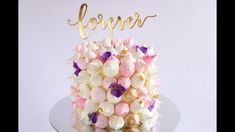 a wedding cake with flowers and the word forever on top