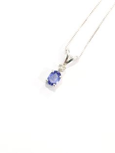 Genuine VERY SMALL oval shaped ( light bluish purple to medium bluish purple depending on the light) tanzanite measures 5x3 mm (1/3 carat). Genuine 1.6mm accent diamond. Both handset in sterling silver. Sterling silver box chain is 18 inches long and can be switched out to a 16 inch chain upon request. Necklace is perfect for a child or the minimalist. Comes in a gift box Blue Oval Diamond Necklace In Fine Jewelry Style, Blue Oval Diamond Necklace Fine Jewelry, Tanzanite Necklaces With Diamond Accents As Gift, Silver Tanzanite Necklace With Diamond Accents, Silver Tanzanite Necklace Fine Jewelry, Fine Jewelry Tanzanite Silver Necklace, White Gold Tanzanite Jewelry With Diamond Accents, Silver Tanzanite Jewelry With Diamond Accents, Fine Jewelry Tanzanite In White Gold