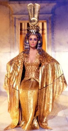 a woman dressed in gold with an egyptian headdress