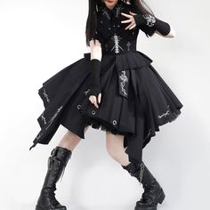 a woman dressed in goth clothing posing for the camera