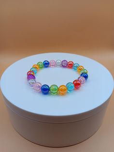 Colorful 8mm glass bead bracelet. It is beautiful in the light especially with all the colors. It can make a great gift for a loved one.  Bracelet is crafted with quality elastic stretch cord for the perfect fit. Bracelet sizes are from 6.5 inches to 8 inches. If your wrist size is not listed then please contact me with your wrist size. I will gladly do a special order. All items are made to order. They are shipped via United States Postal Service with a tracking number. Items will be shipped wi Iridescent Beaded Bracelets With Colorful Beads As Gift, Iridescent Beaded Bracelets As Gift, Clear Beaded Bracelets For Gift, Clear Beaded Bracelets As A Gift, Rainbow Hypoallergenic Bracelets As Gift, Hypoallergenic Rainbow Bracelets As Gift, Multicolor 8mm Beads Wristband For Gift, Multicolor 8mm Bead Wristband Gift, Hypoallergenic Rainbow Bracelets With Round Beads