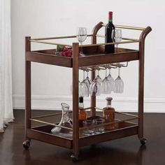 a bar cart with wine glasses and bottles on it