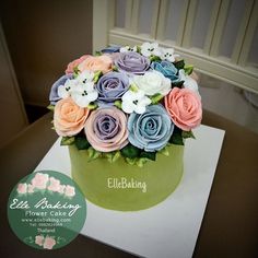 there is a green cake with flowers on it