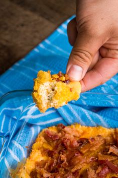 a person holding a piece of food in their hand