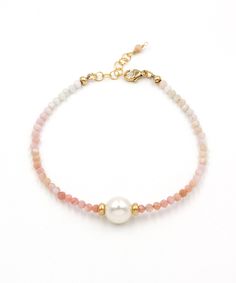 A lustrous freshwater pearl and an ombre fade of pink opal are layered together to create this fresh seaside style. Crafted to last for years to come from natural gemstones and high quality 14k gold fill that is hypoallergenic and waterproof. *Pairs with our Adria Pearl Ombre Necklace >> https://www.etsy.com/listing/1525106461 Materials: Freshwater pearl | Pink Opal | 14k gold filled beads, clasp and extender Measurements: 7 - 8" Adjustable Length | 10 mm pearl, 3.5 mm gemstones Handcrafted in F Ombre Bracelet, Ombre Necklace, Indigo Design, Coastal Jewelry, Seaside Style, Pearl Pink, Tassel Jewelry, Opal Bracelet, Pink Ombre