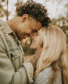 a man and woman smiling at each other