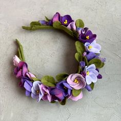 a wreath made out of felt flowers and leaves