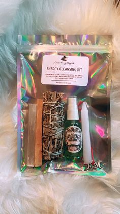 the contents of an energy cleaning kit in a clear package on a white furry surface