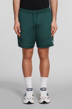 Shorts in green polyester, elasticated waistband, coulisse closure, perfored, side logo print, Made in Cambodia, Model is 1. 83 and wears size M Green Drawstring Bottoms For Streetwear, Green Sports Shorts With Elastic Waistband, Green Athletic Shorts With Elastic Waistband For Sports, Green Nylon Bottoms With Elastic Waistband, Green Nylon Shorts With Functional Drawstring, Athleisure Green Shorts With Elastic Waistband, Green Nylon Bottoms With Functional Drawstring, Green Relaxed Fit Athletic Shorts, Green Relaxed Fit Gym Bottoms