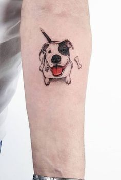 a dog with a bone in it's mouth tattoo on the left inner arm