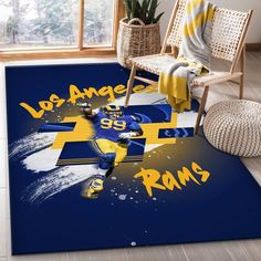 a blue rug with the name los angeles rams on it in front of a chair