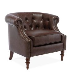 a brown leather chair with studding on the armrests and nail - tipped legs