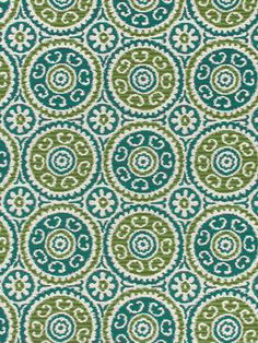 a green and white fabric with circular designs