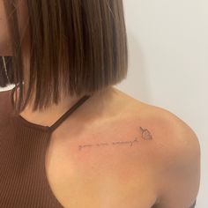 a woman with a small tattoo on her shoulder