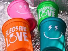 three plastic cups with the words electric love written on them