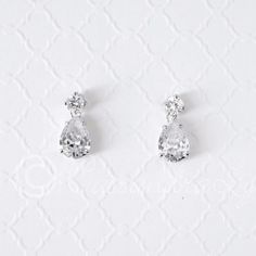 pair of diamond earrings on white background