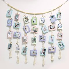 a bunch of pictures hanging on a wall with tassels and beads around them