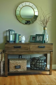 a wooden table with baskets underneath it and a mirror on the wall above it that says makeover