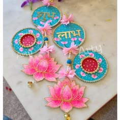 three pink and blue flowers are on a marble table with the word happy written in it