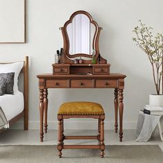 a bedroom with a vanity, stool and mirror