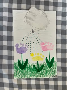 a child's drawing of flowers and a watering can